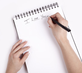  Note Pad with a hand write on it I Love you.