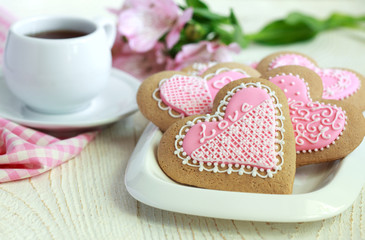 Gingerbread in the shape of heart with pink and white frosting