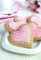 Gingerbread in the shape of heart with pink and white frosting