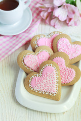 Gingerbread in the shape of heart with pink and white frosting