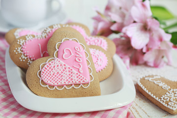 Gingerbread in the shape of heart with pink and white frosting