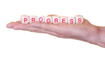 Progress written with wooden dice on a isolated hand