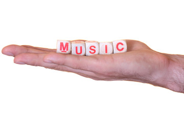Music written with wooden dice on a hand, isolated on white background