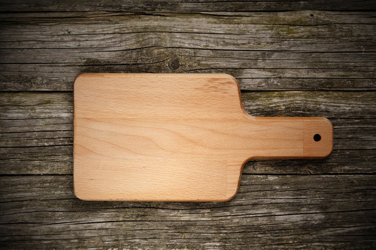 Cutting board on wooden background