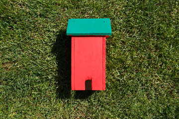 Toy house on grass close-up