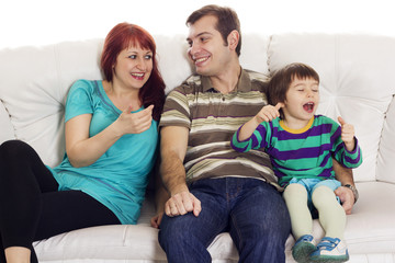 Father, mother and son sitting on the sofa