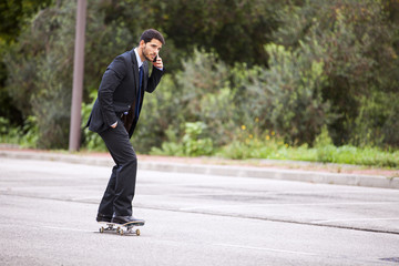 Businessman skateboarding
