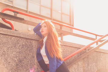 Beautiful redhead girl posing in an urban context