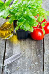 basil tomatoes and olive oil on wooden surface
