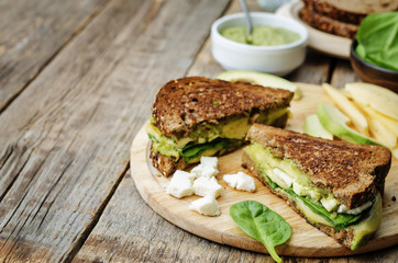 grilled rye sandwiches with cheese, spinach, pesto, avocado and
