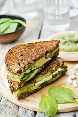 grilled rye sandwiches with cheese, spinach, pesto, avocado and