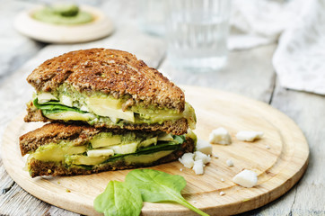 grilled rye sandwiches with cheese, spinach, pesto, avocado and