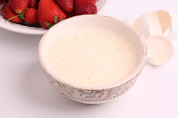 whipped to a froth the eggs in a bowl on a white background selective soft focus