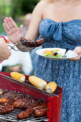 Woman being on diet refusing sausage
