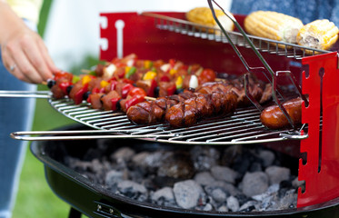 Sausages, shiskebabs and corns on the grill