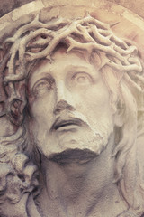 Close up dramatic statue of crucified Jesus Christ (styled vinta