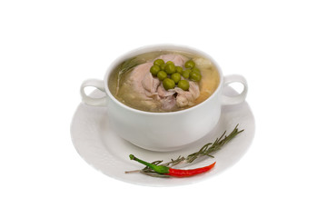 Chicken soup with green peas on a white background organic healthy food