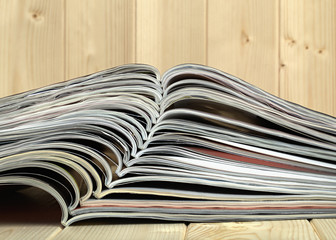 Stack of magazines on a wooden background