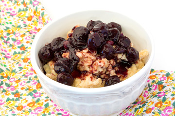breakfast oatmeal with cherry jam in a white ceramic bowl shabby chic retro vintage health diet selective soft focus