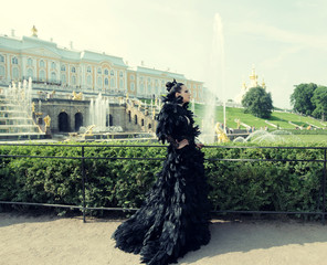 Princess in the park next to the fountain 