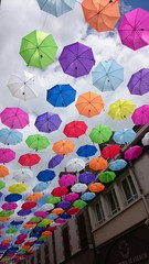 Fototapeta na wymiar Umbrellas hanging in the street.