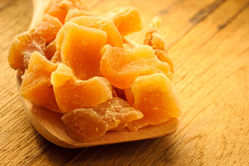 Closeup candied ginger on wooden spoon