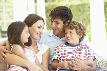 Family Group Relaxing On Sofa Together