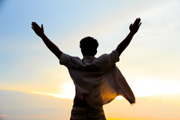 Stock Photo - silhouette of single man action at sunset.