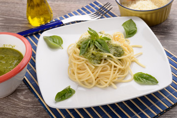 Spaghetti al pesto with basil leaves