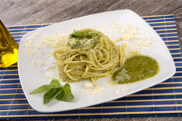 Spaghetti al pesto with basil leaves