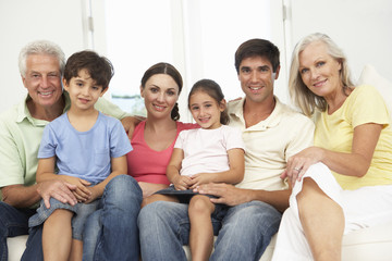 Fototapeta premium Extended Family Relaxing On Sofa At Home Together