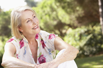 Portrait Of Senior Woman Relaxing In Countryside