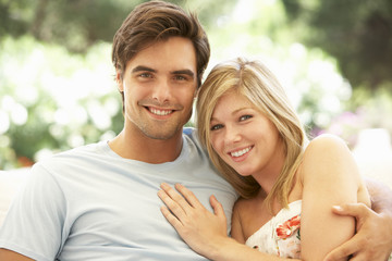 Naklejka premium Portrait Of Young Couple Relaxing On Sofa