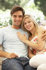 Naklejka premium Portrait Of Young Couple Relaxing On Sofa