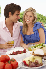 Young Couple Enjoying Outdoor Meal Together
