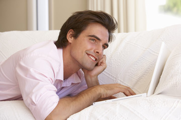 Young Man Using Laptop At Home