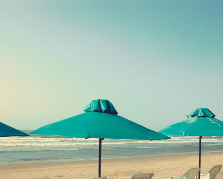 Retro beach with green umbrellas