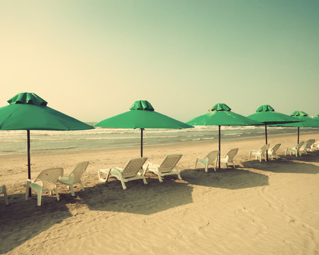 Retro beach with green umbrellas