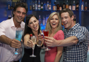 Group Of Young Friends Enjoying Drink In Bar