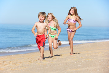 Children Running Along Summer Beach