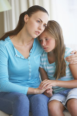 Mother Comforting Daughter At Home