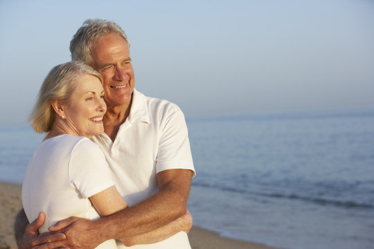Senior Couple Enjoying Beach Holiday - Powered by Adobe