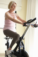Fototapeta na wymiar Senior Woman On Exercise Bike