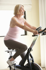 Obraz na płótnie Canvas Senior Woman On Exercise Bike