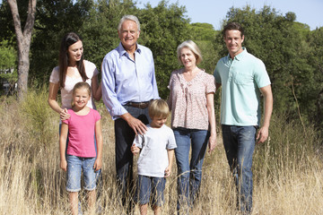 Extended Family Walking Through Summer Countryside