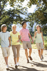 Middle Aged Family Walking Through Countryside