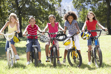 Group Of Children Riding Bikes In Countryside
