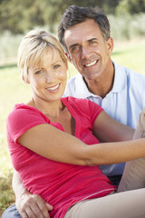 Obraz premium Middle Aged Couple Relaxing In Countryside