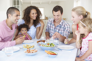 Families Enjoying Meal Together At Home