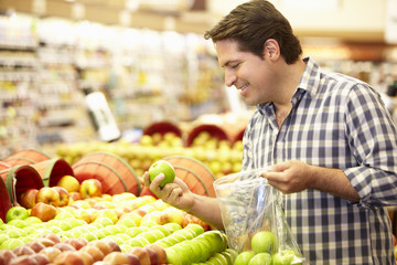 Man Shopping For Produce In Supermarket